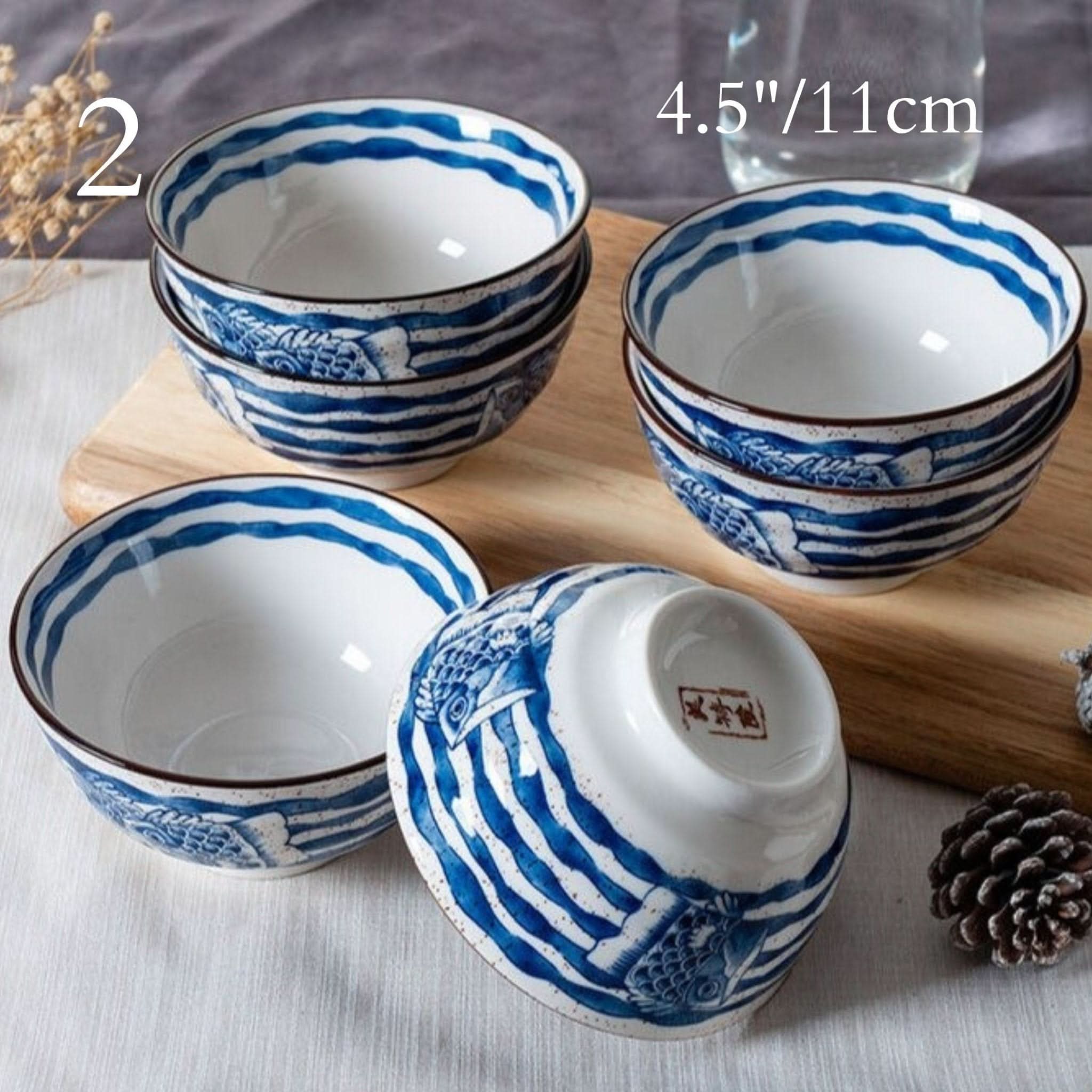 Ceramic glazed 4.5" bowls with blue Japanese illustrations, perfect for noodles or soup.